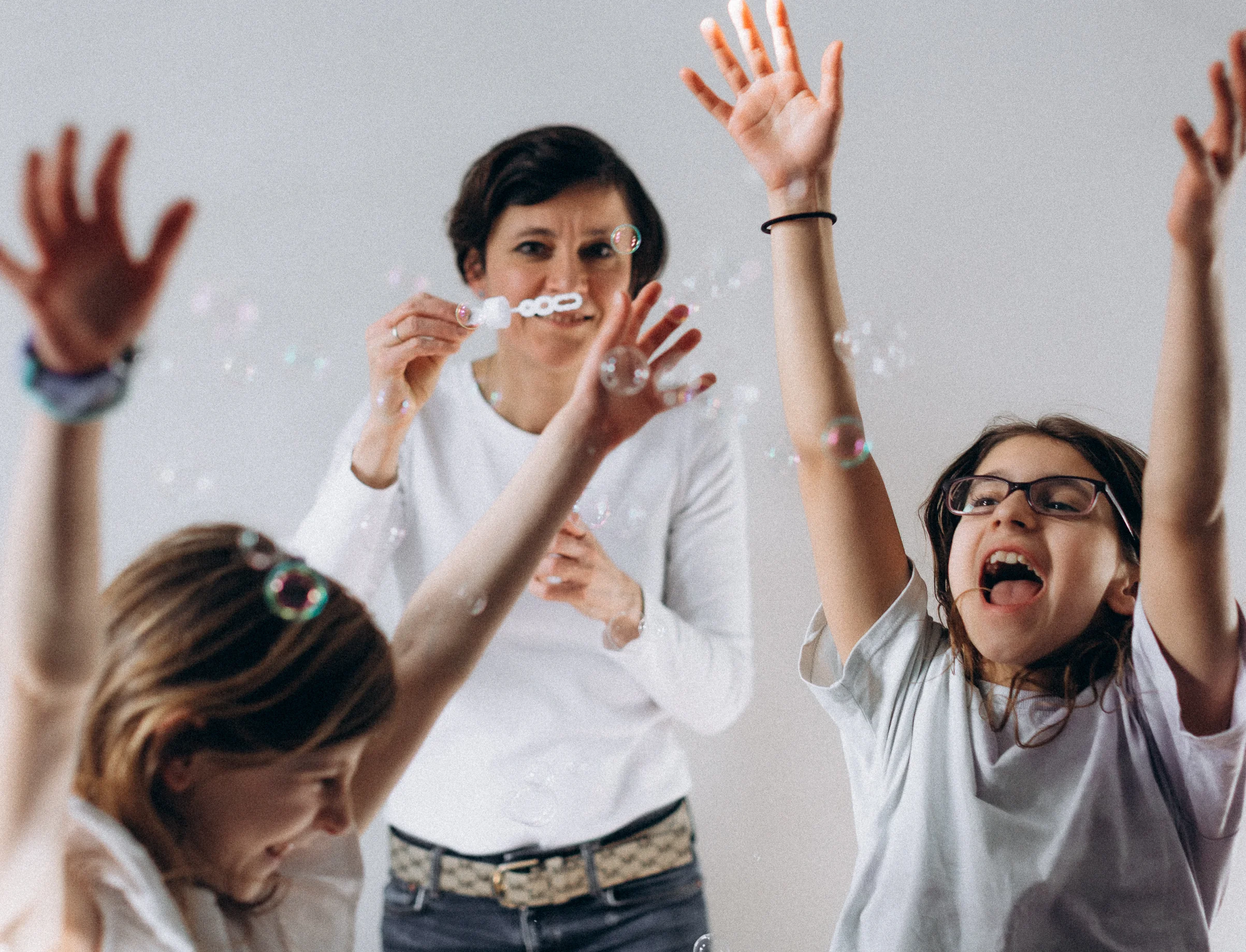 Irina Dmitrieva laughing and playing with her children, a joyful and candid family moment.